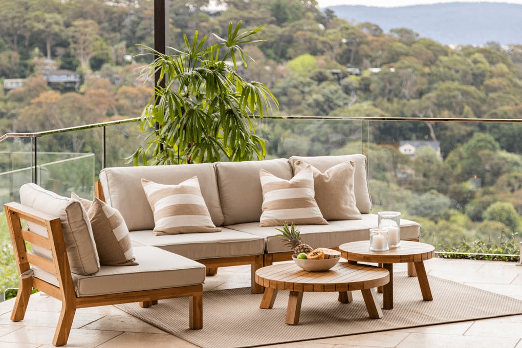 An outdoor couch on a balcony.